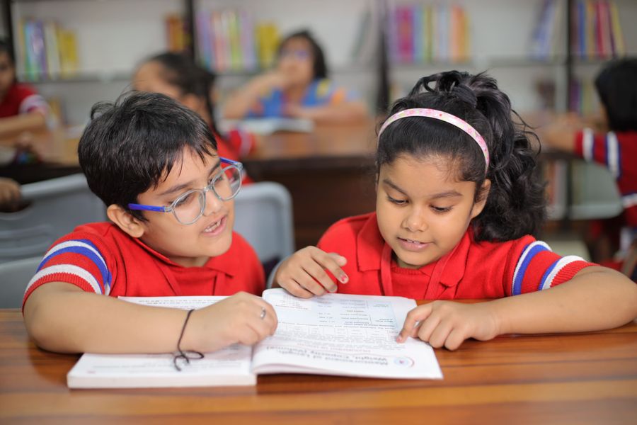 Indian children reading together in a classroom