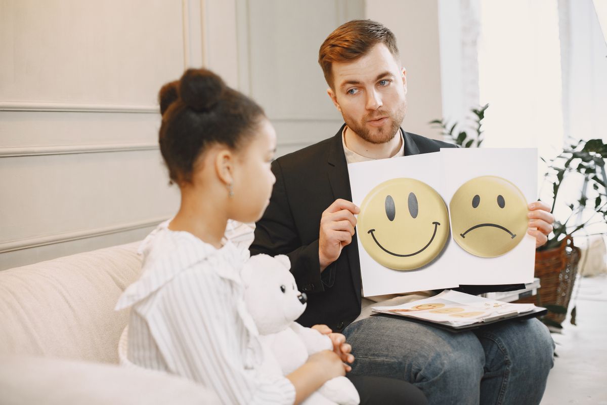 Counsellor using emotion cards to support a child